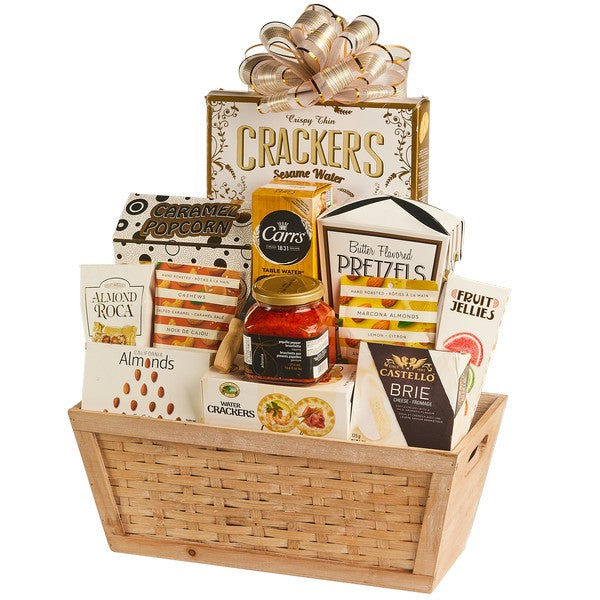 Gourmet snack gift basket in a woven wooden basket with crackers, brie, pretzels, almonds and a gold bow