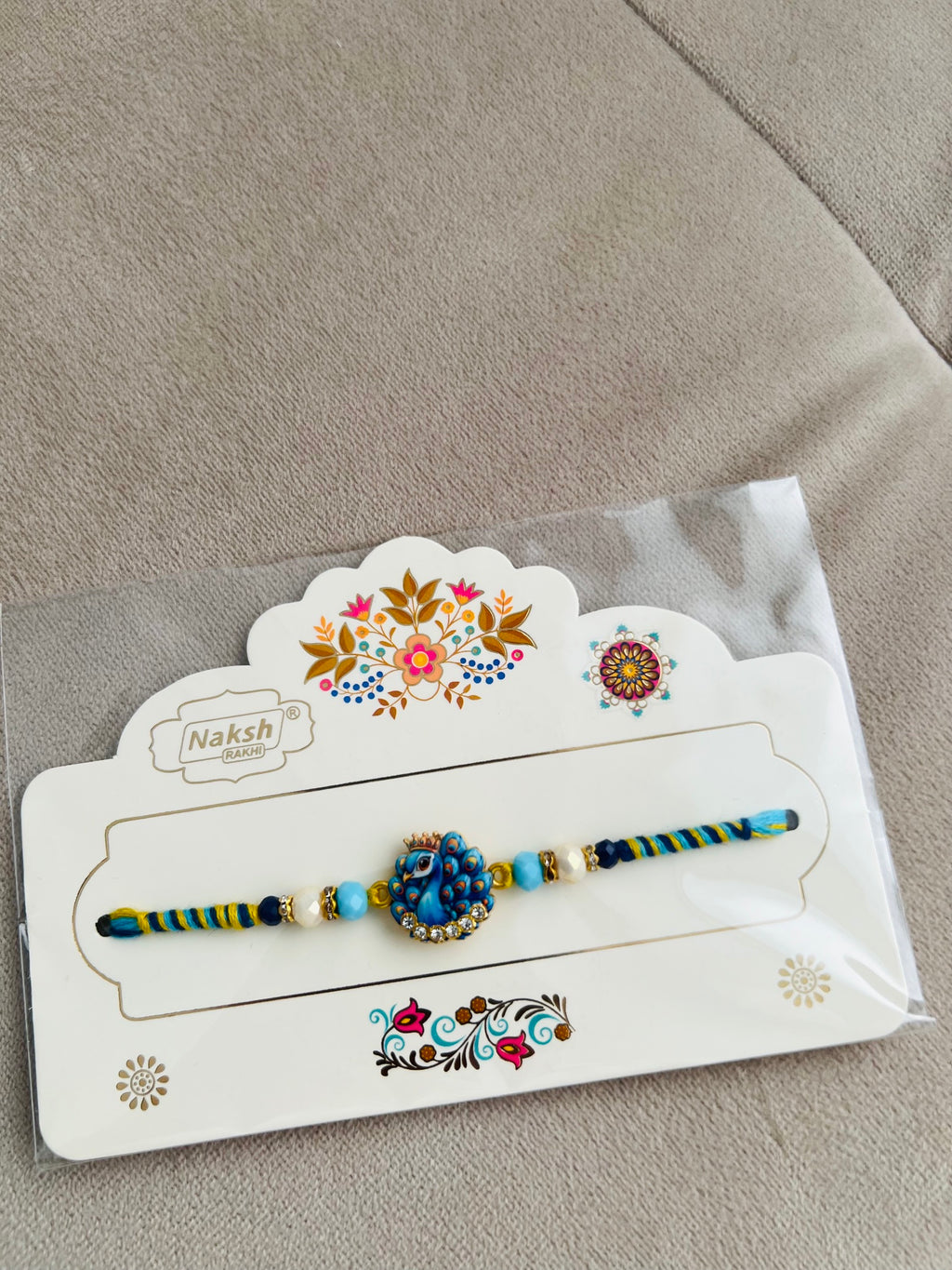 Designer Peacock Rakhi – Blue & Gold Pendant, Premium Beads