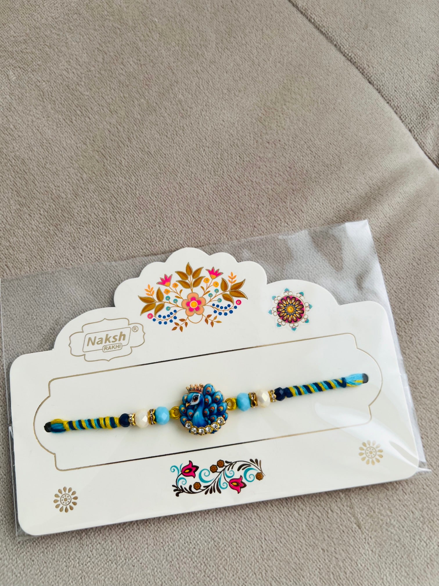 Designer Peacock Rakhi – Blue & Gold Pendant, Premium Beads