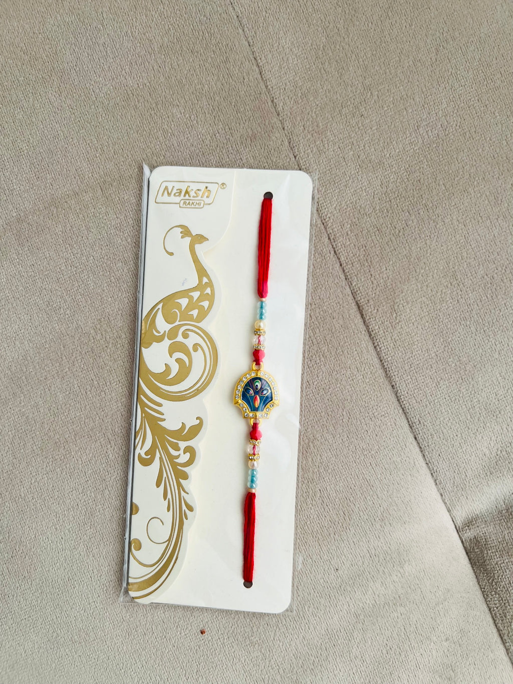Designer Kundan Peacock Rakhi – Blue & Gold Centerpiece, Premium Beads
