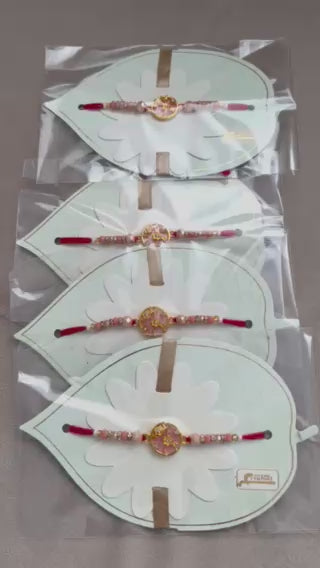 Designer Floral Rakhi – Pink Stone Centerpiece, Gold Beads & Premium Packaging
